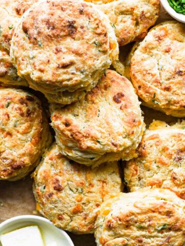 Close up shot of a stack of cheddar chive biscuits.