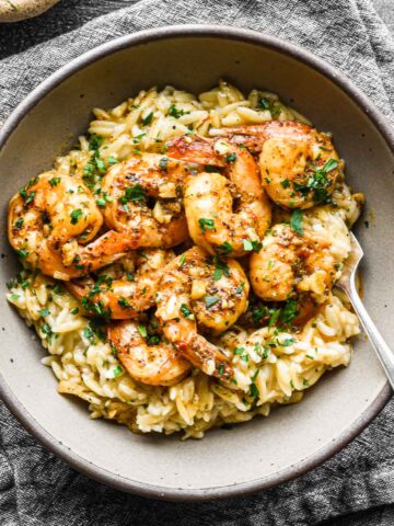 Finished shrimp and rice dish in a bowl with a napkin.