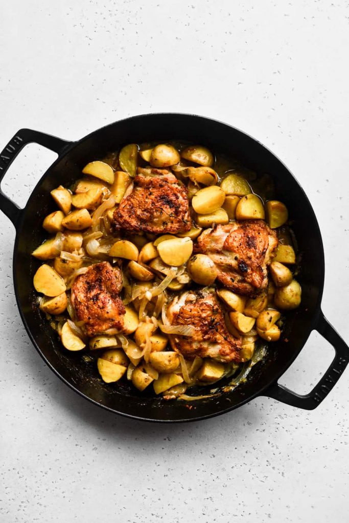 Apple Cider Braised Chicken Thighs in black Staub Braiser.