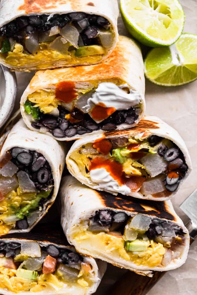 Vegetarian Breakfast Burritos with hot sauce and sour cream