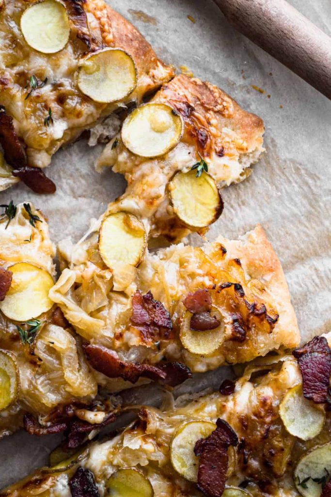 Bite of caramelized onion and bacon pizz
