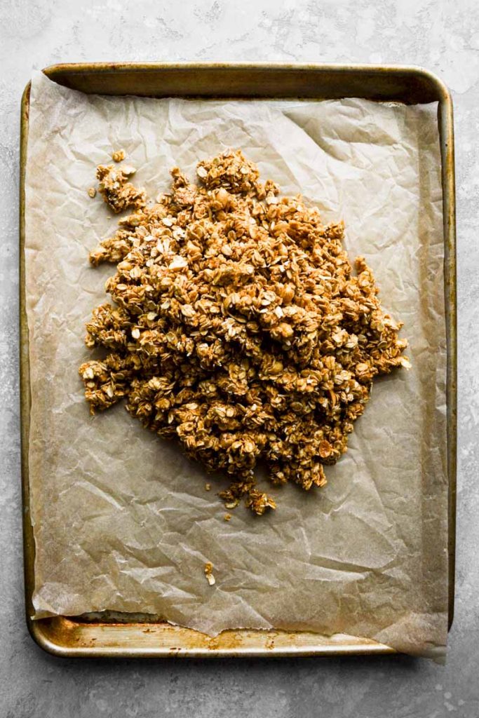 Peanut butter granola poured on baking sheet