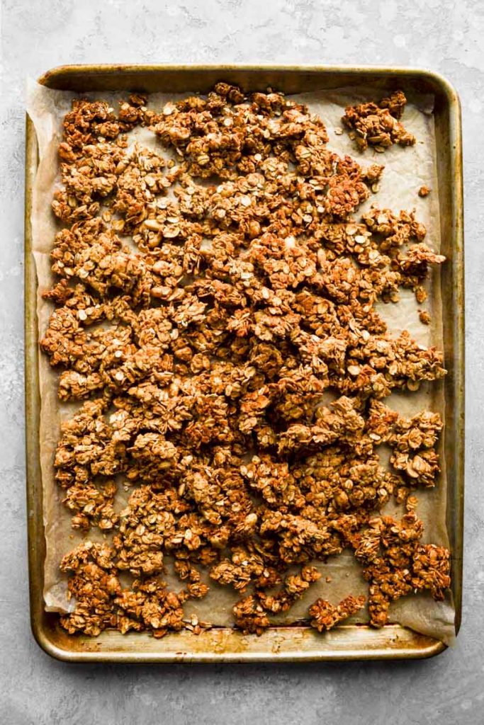 Peanut butter granola broken on baking sheet