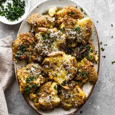 Air Fryer Smashed Potatoes on an oval plate