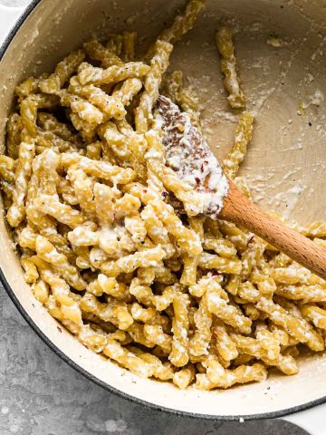 Close up of half-eaten bowl of lemon ricotta pasta