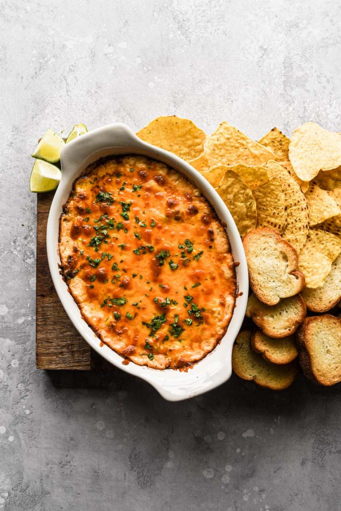 Dip on wood platter with chips and bread