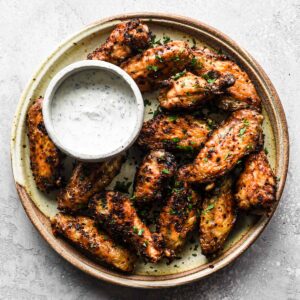 Up close of the wings on a round serving plate.