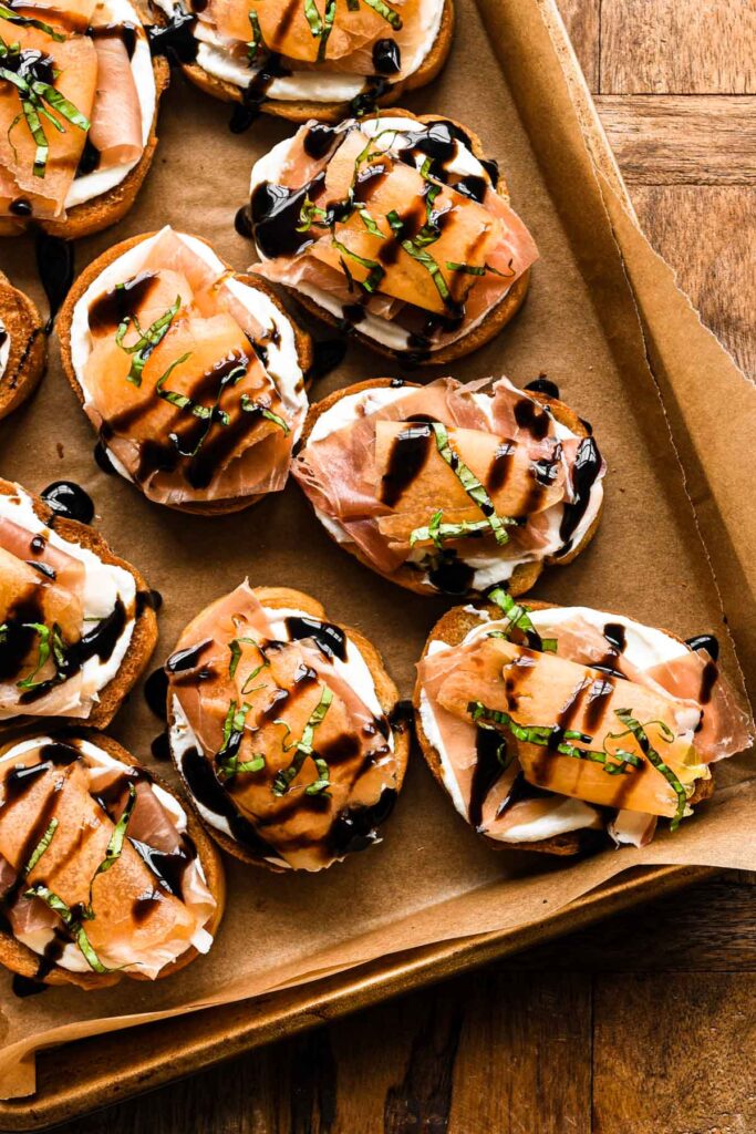 Up close of the crostini on a baking sheet.