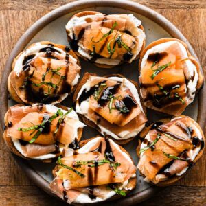 Thumbnail with finished crostini on a round plate.