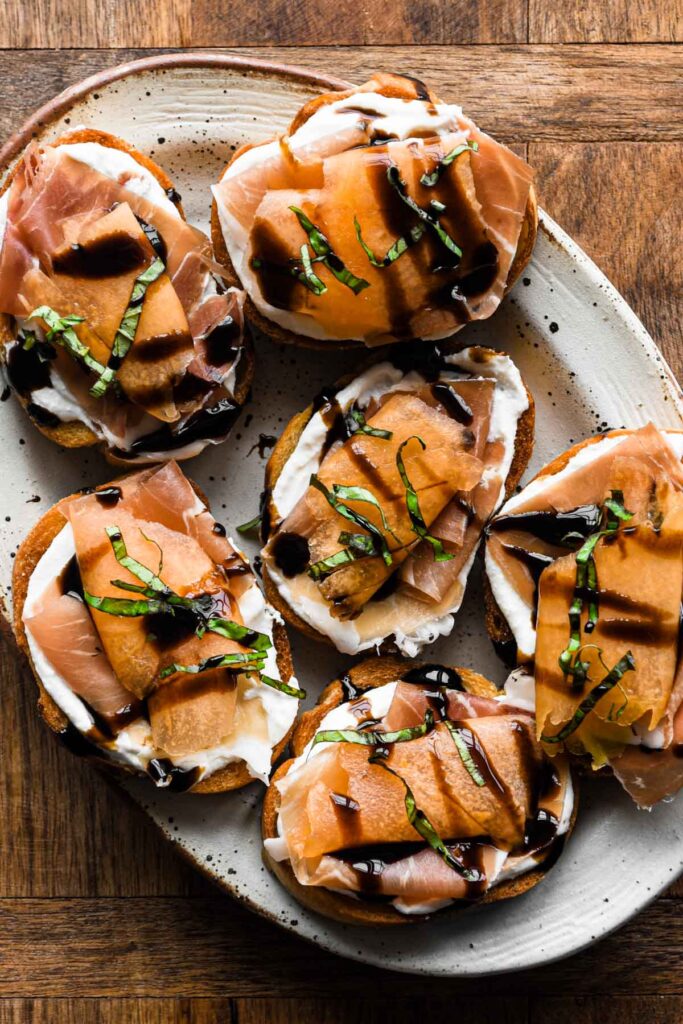 Crostini on a oval plate angled.