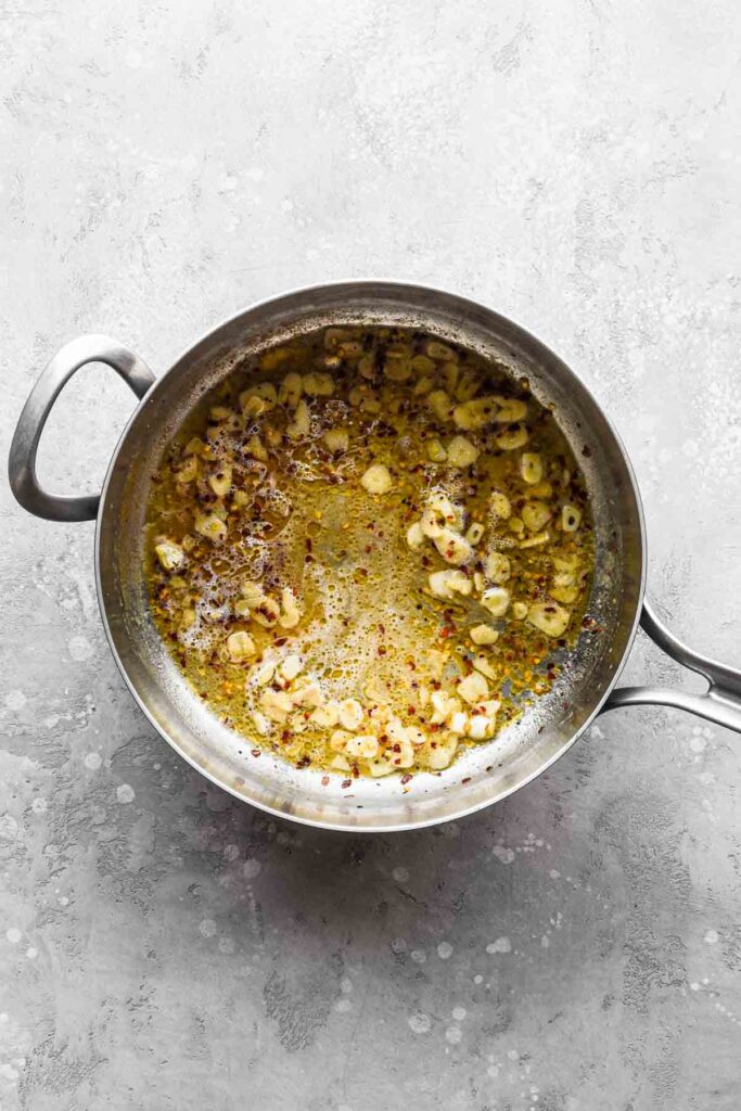 Wine added to the pan with garlic and red pepper flakes.