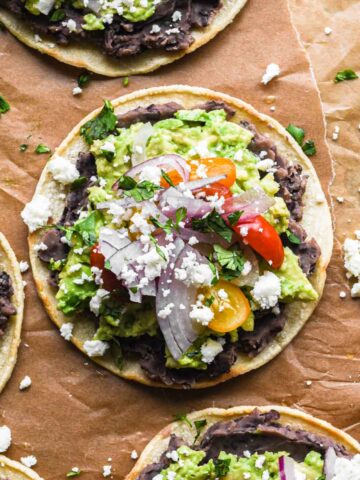 Up close of finished tostada with cheese and cilantro.
