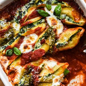 Close up shot of stuffed shells being served.