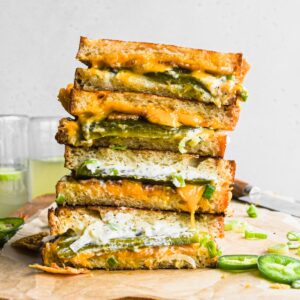 Two grilled cheese sandwiches stacked on top of each other.