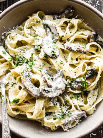 Mushroom mascarpone pasta in a bowl with fresh parsley on top.