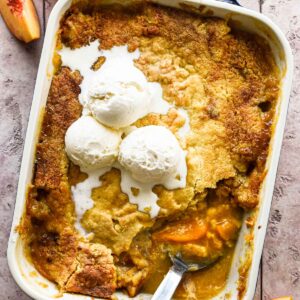 Cake mix peach cobbler with ice cream on top.