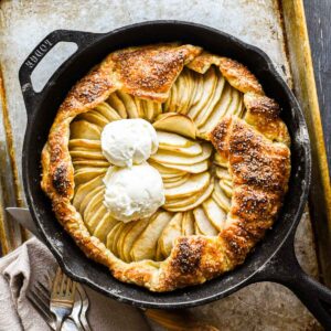 Finished galette in a cast iron pan with two scoops of ice cream.