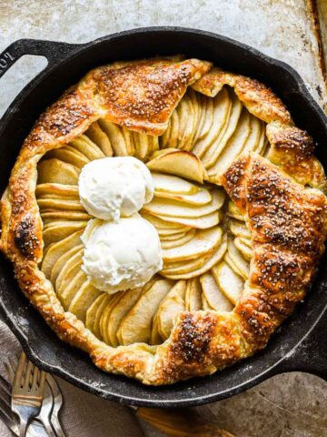 Finished galette in a cast iron pan with two scoops of ice cream.
