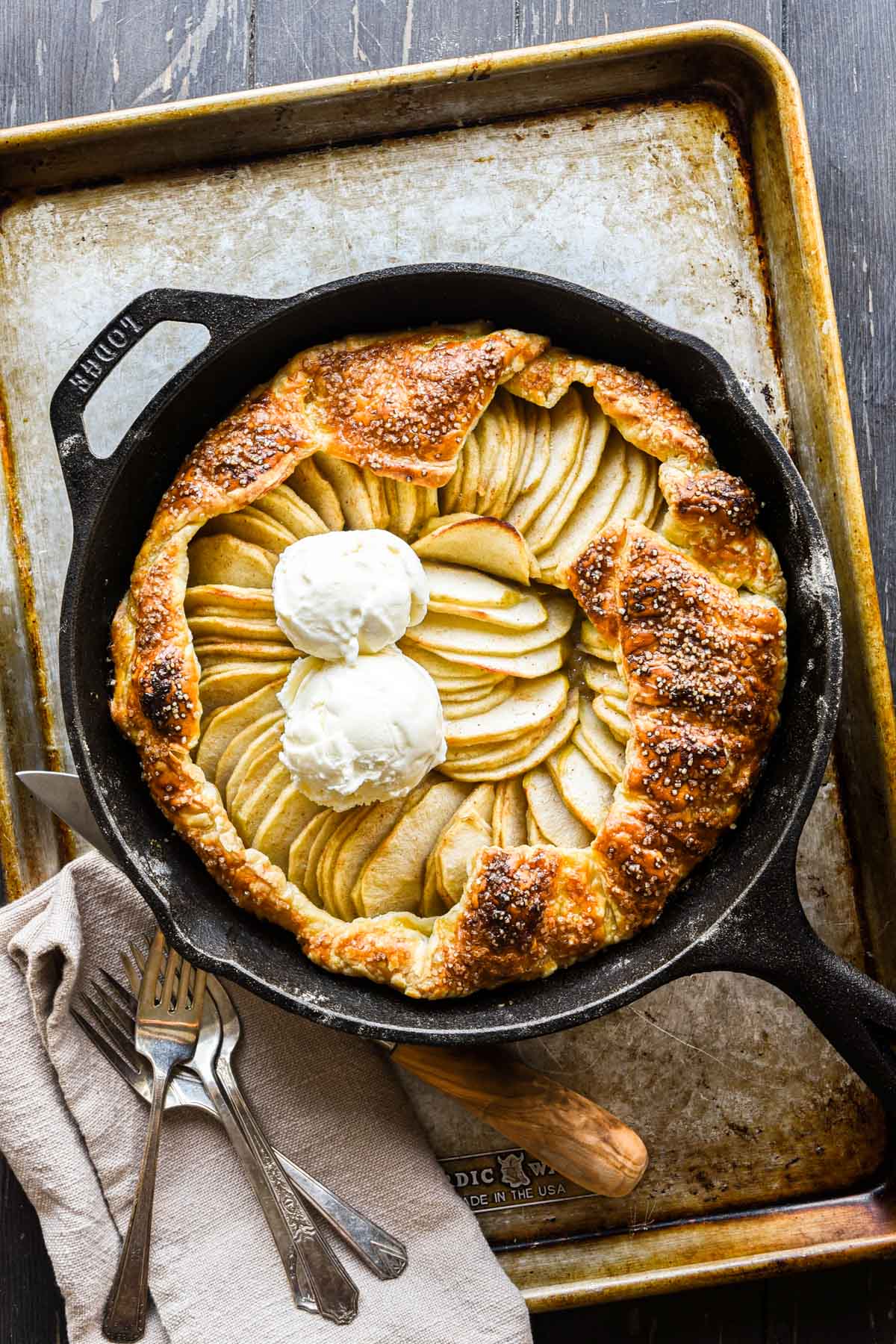 Finished galette in a cast iron pan with two scoops of ice cream.