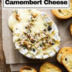 Overhead image of baked camembert cheese with crostini.