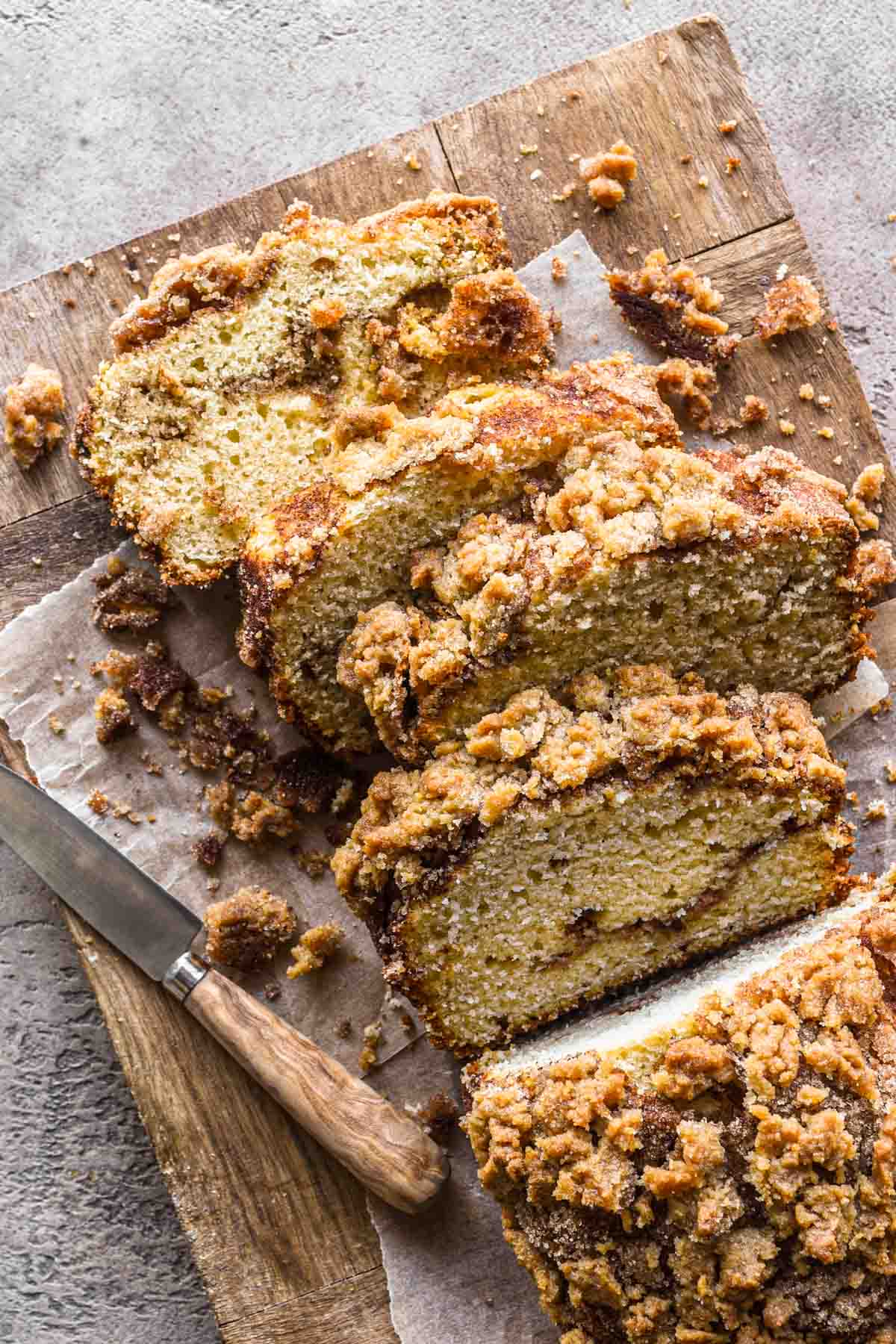 Overhead image of cake sliced on a wood board.