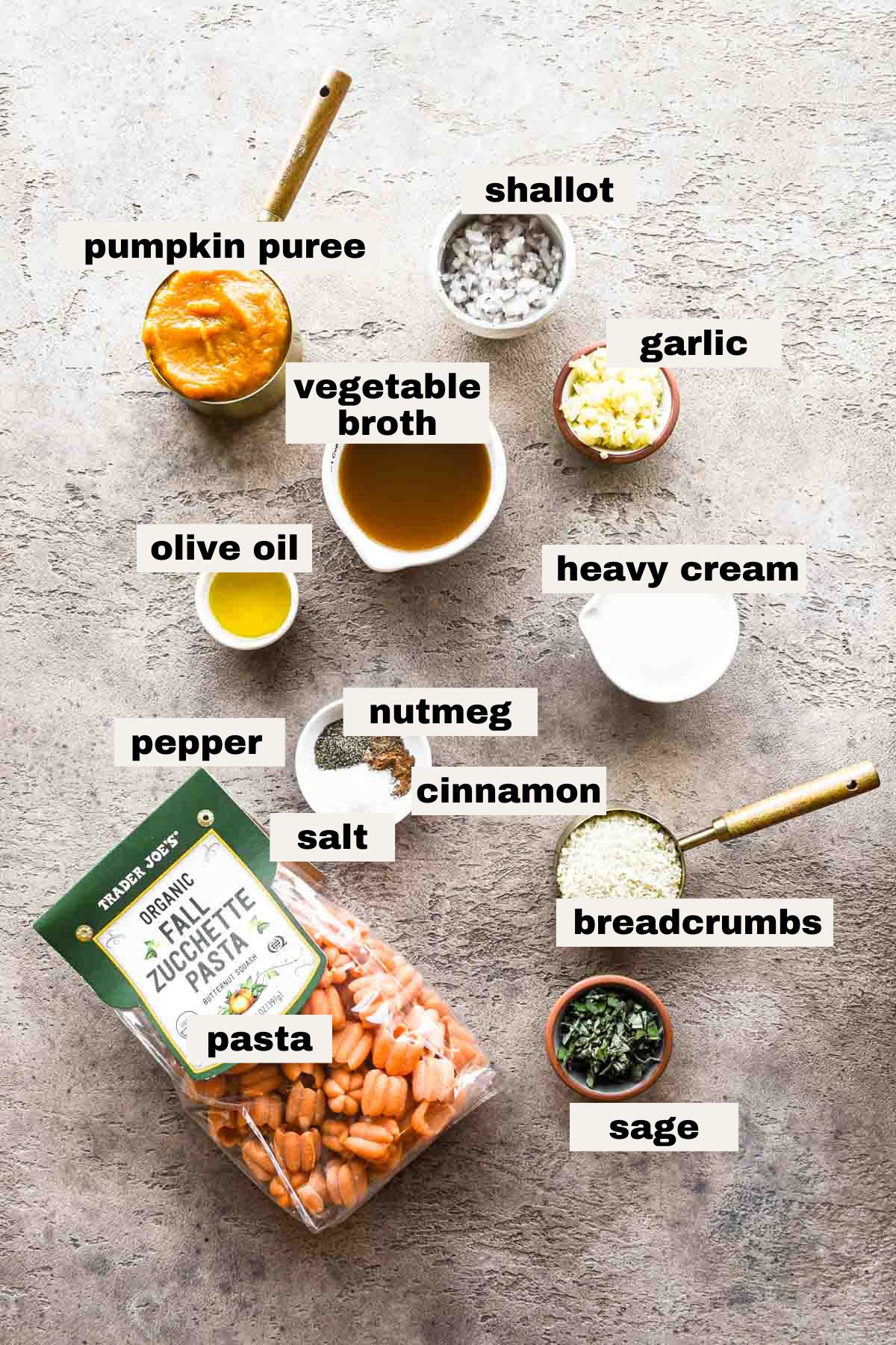 Ingredients on a table that are needed to make creamy pumpkin pasta.