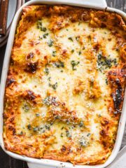 Overhead image of lasagna fresh out of the oven with sage on top.