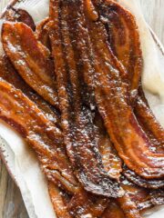 close up image of maple candied bacon on a plate.
