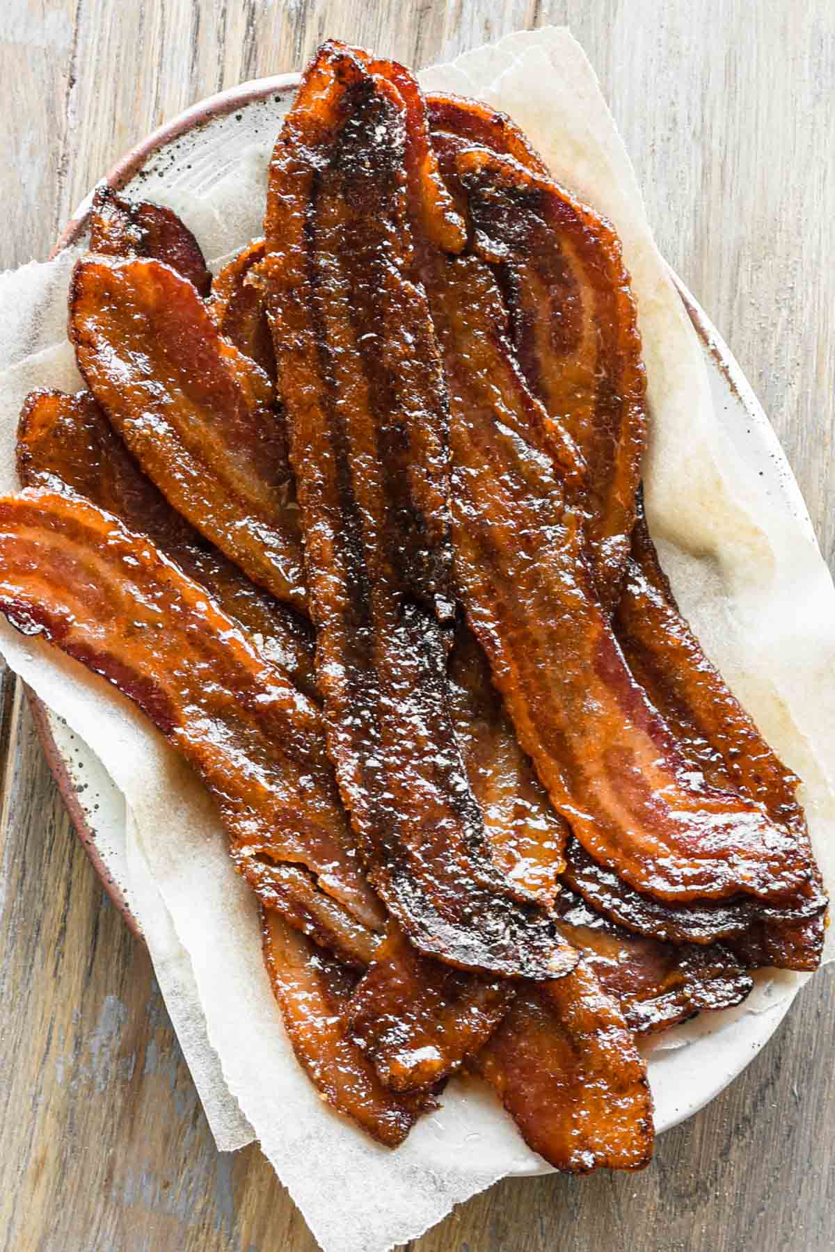 close up image of maple candied bacon on a plate.