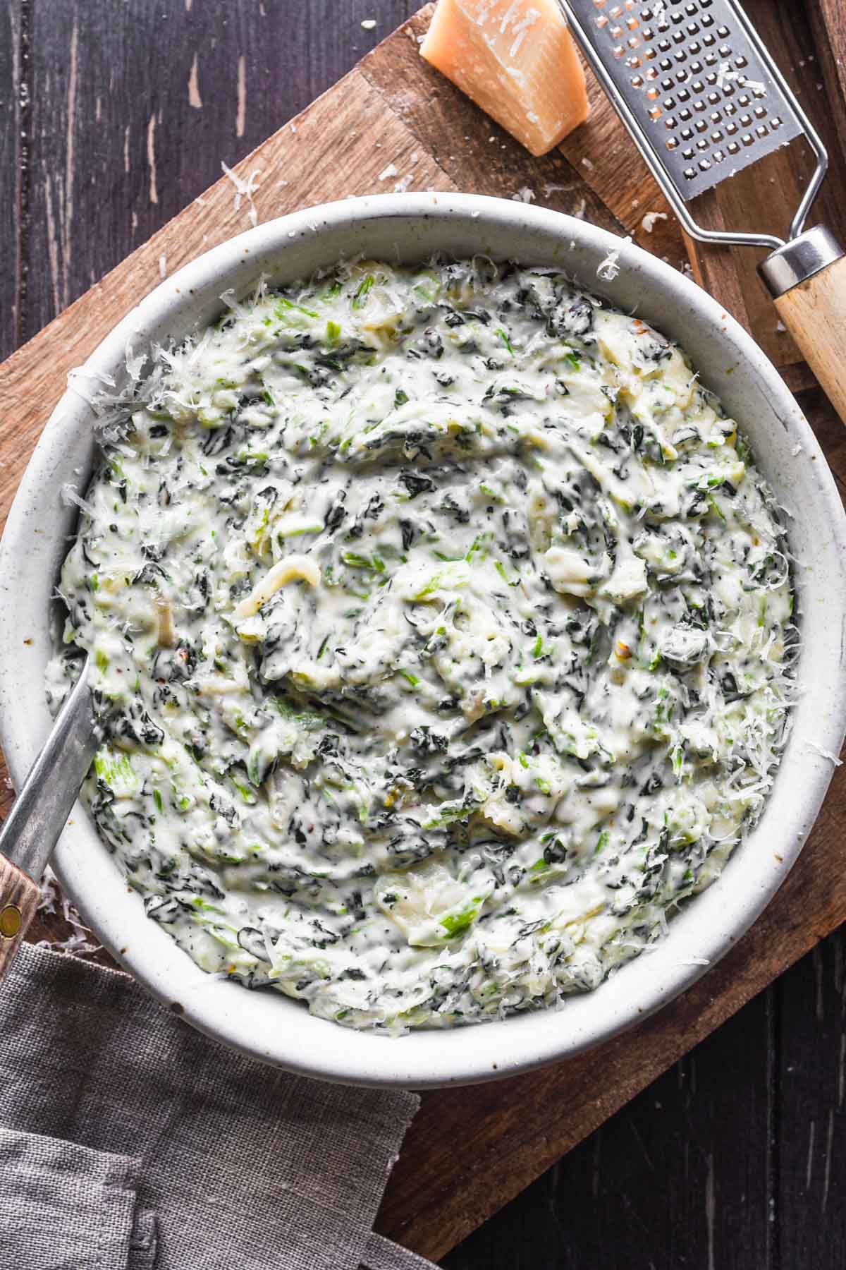 Close up image of asiago creamed spinach in a bowl.