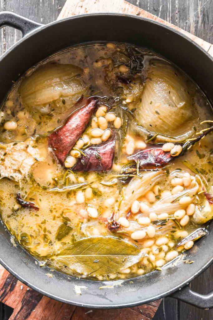Close up of beans cooked in the broth.