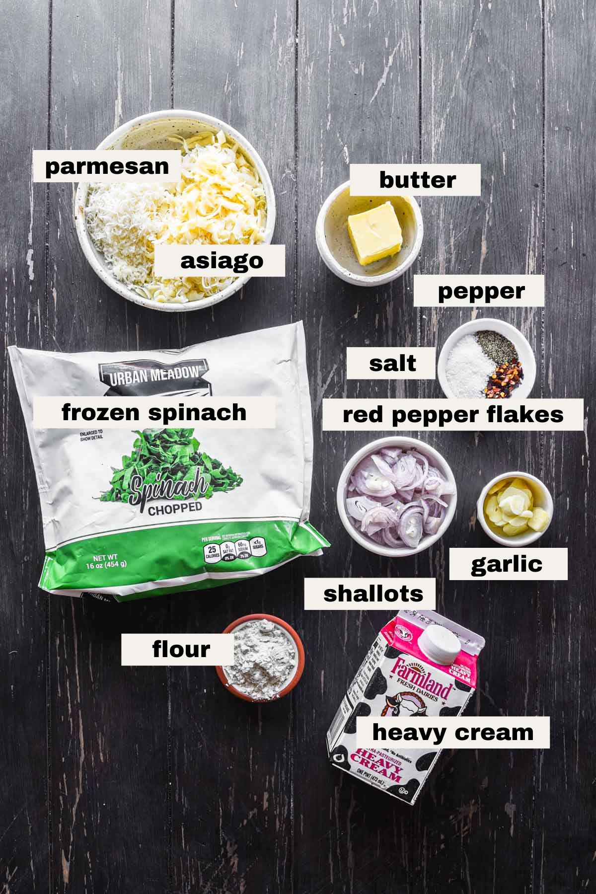 Ingredients on a table needed to make asiago creamed spinach.