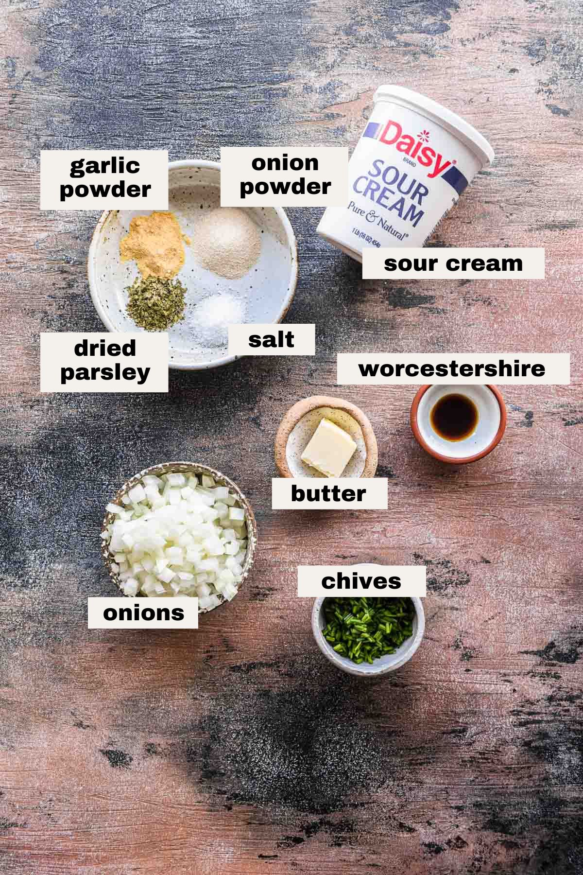 Ingredients on a table that are needed for sour cream and onion dip.