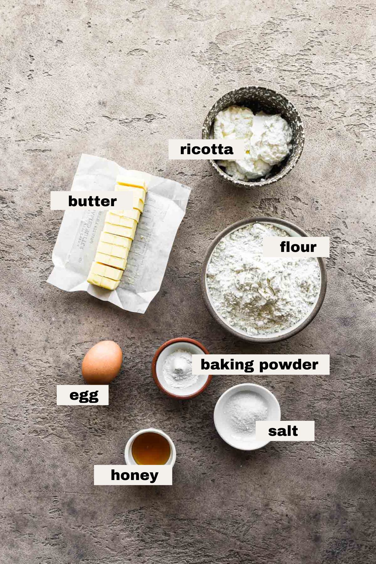 Ingredients to make ricotta biscuits on a table.