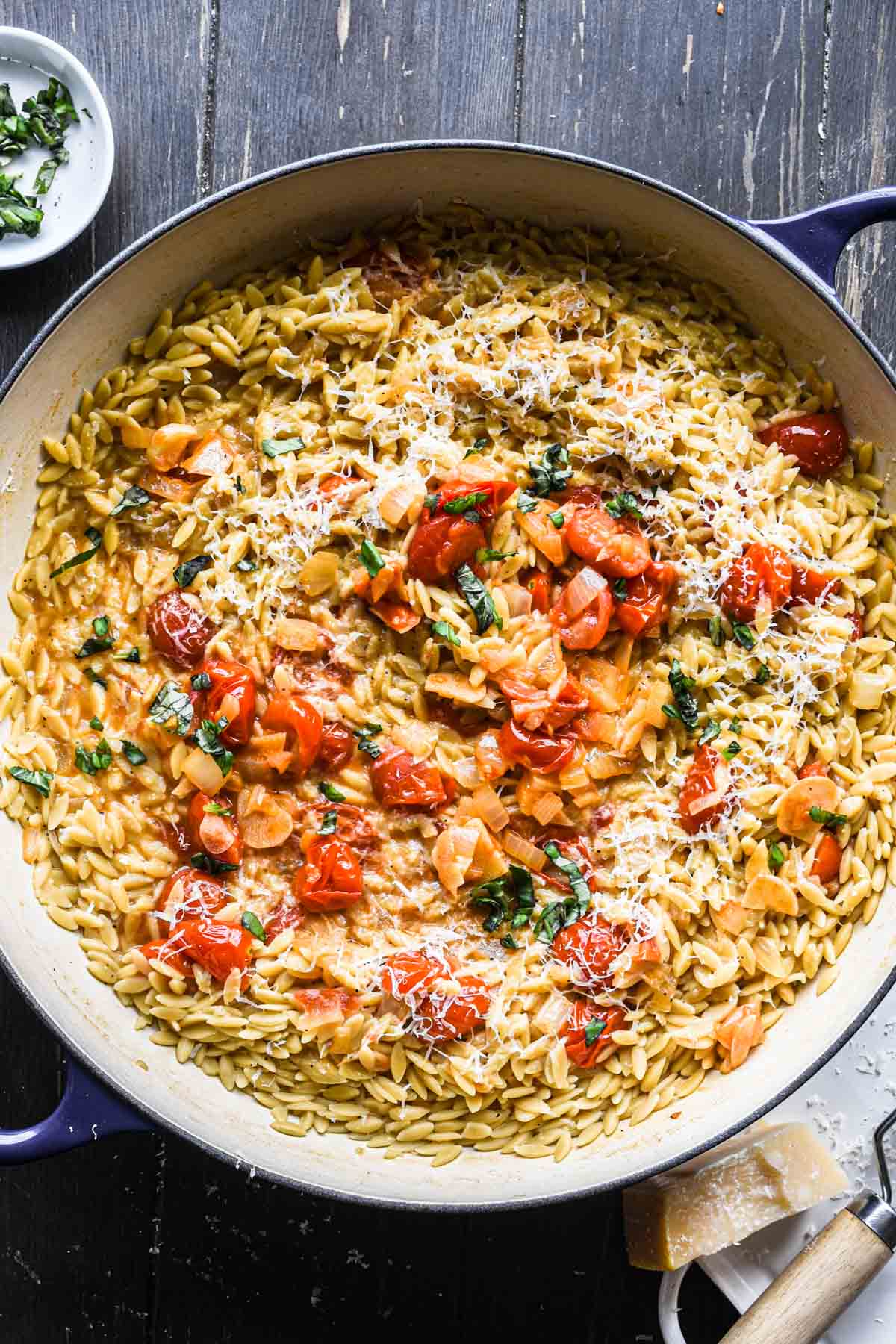 Overhead close up image of finished orzo with tomatoes.