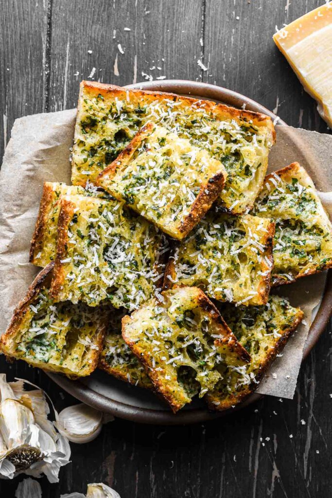 Garlic bread slices in a bowl.