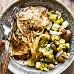 Finished chicken and leeks in a bowl.