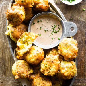 Close up of corn fritters in a basket.