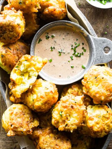 Close up of corn fritters in a basket.