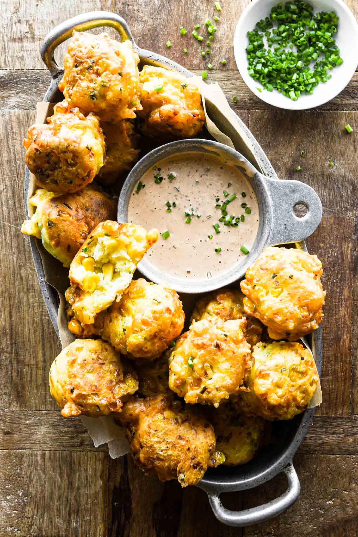 Close up of corn fritters in a basket.
