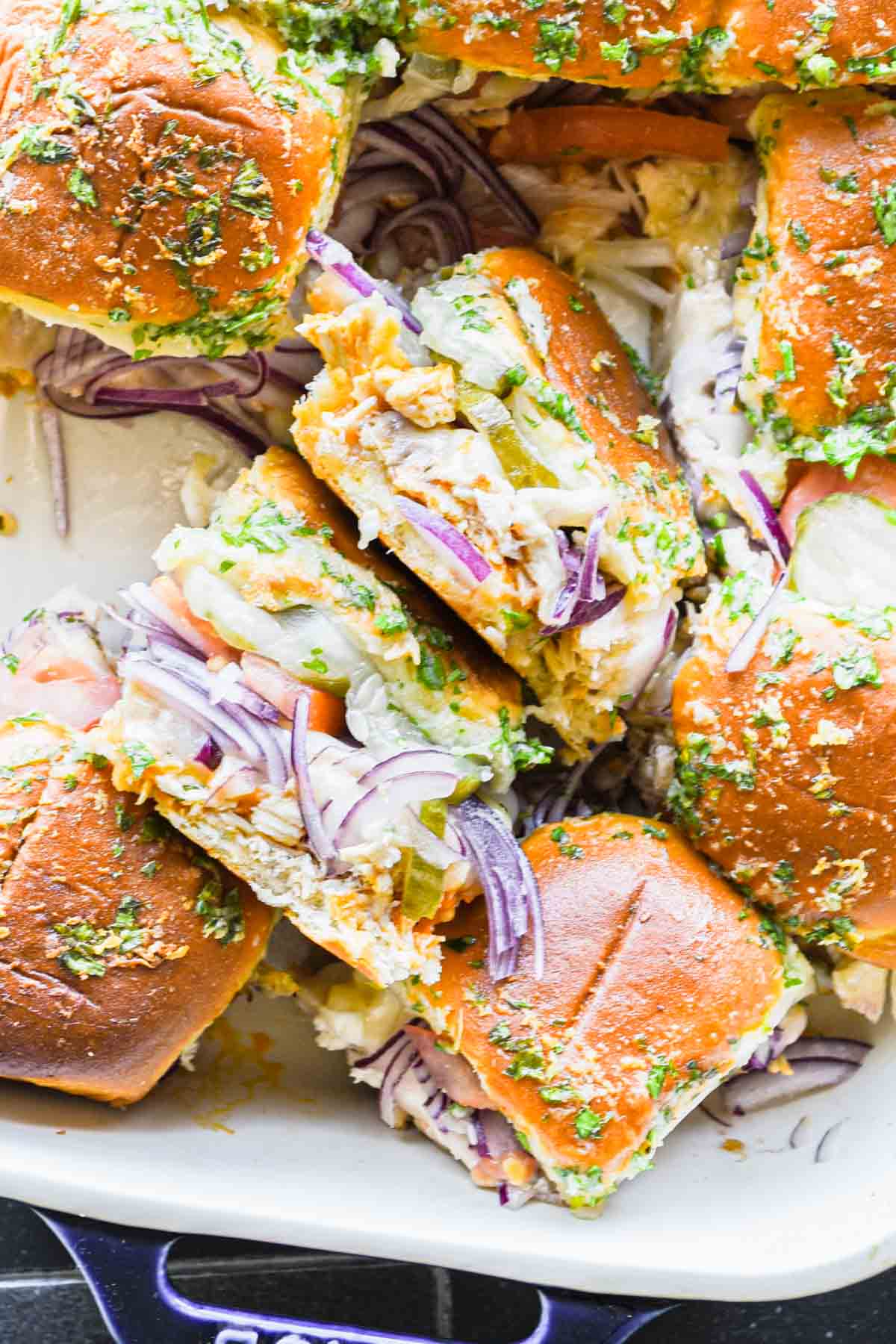 Close up image of two sliders on their side in baking dish.
