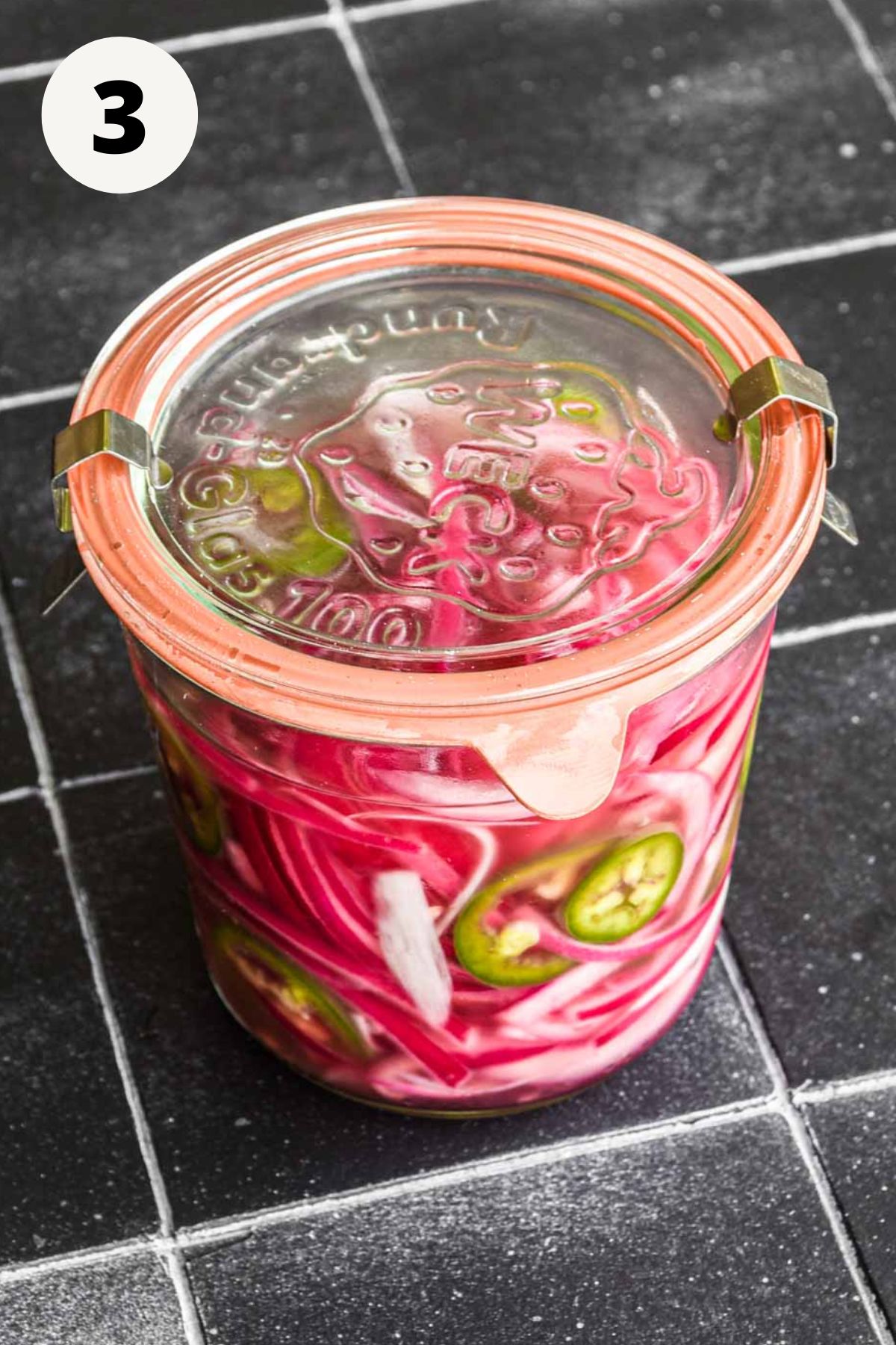 Onions in a jar to be pickled.
