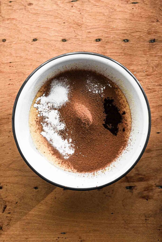 Adding cocoa powder, baking powder, baking soda, espresso powder, salt.