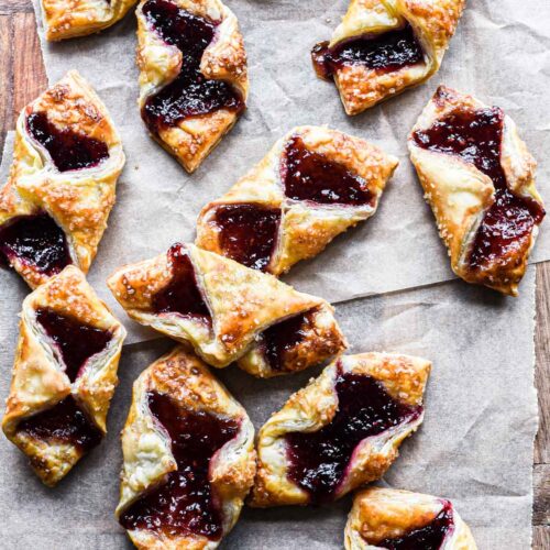 Close up image of puff pastry jam tartlets on a serving board.