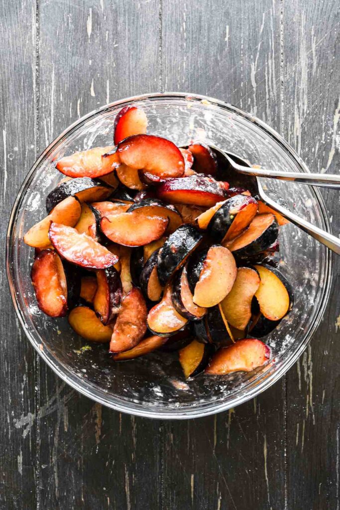 Sliced plums in a bowl.