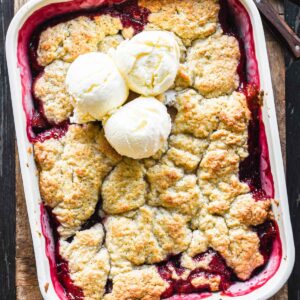 Close up image of baked plum cobbler.