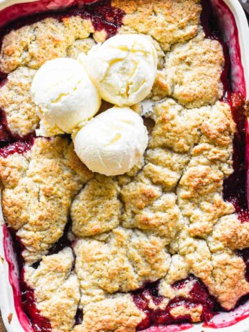 Close up image of baked plum cobbler.