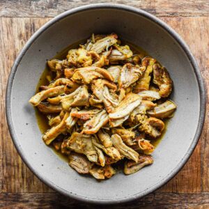 Shredded chicken thighs in a bowl.