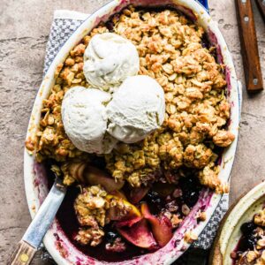 Freshly baked apple blueberry crumble with ice cream.