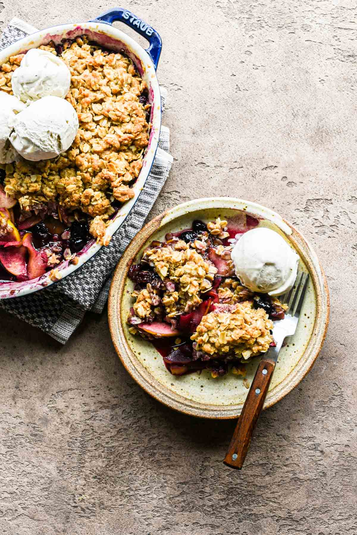 Single plate of crumble next to the baking dish.